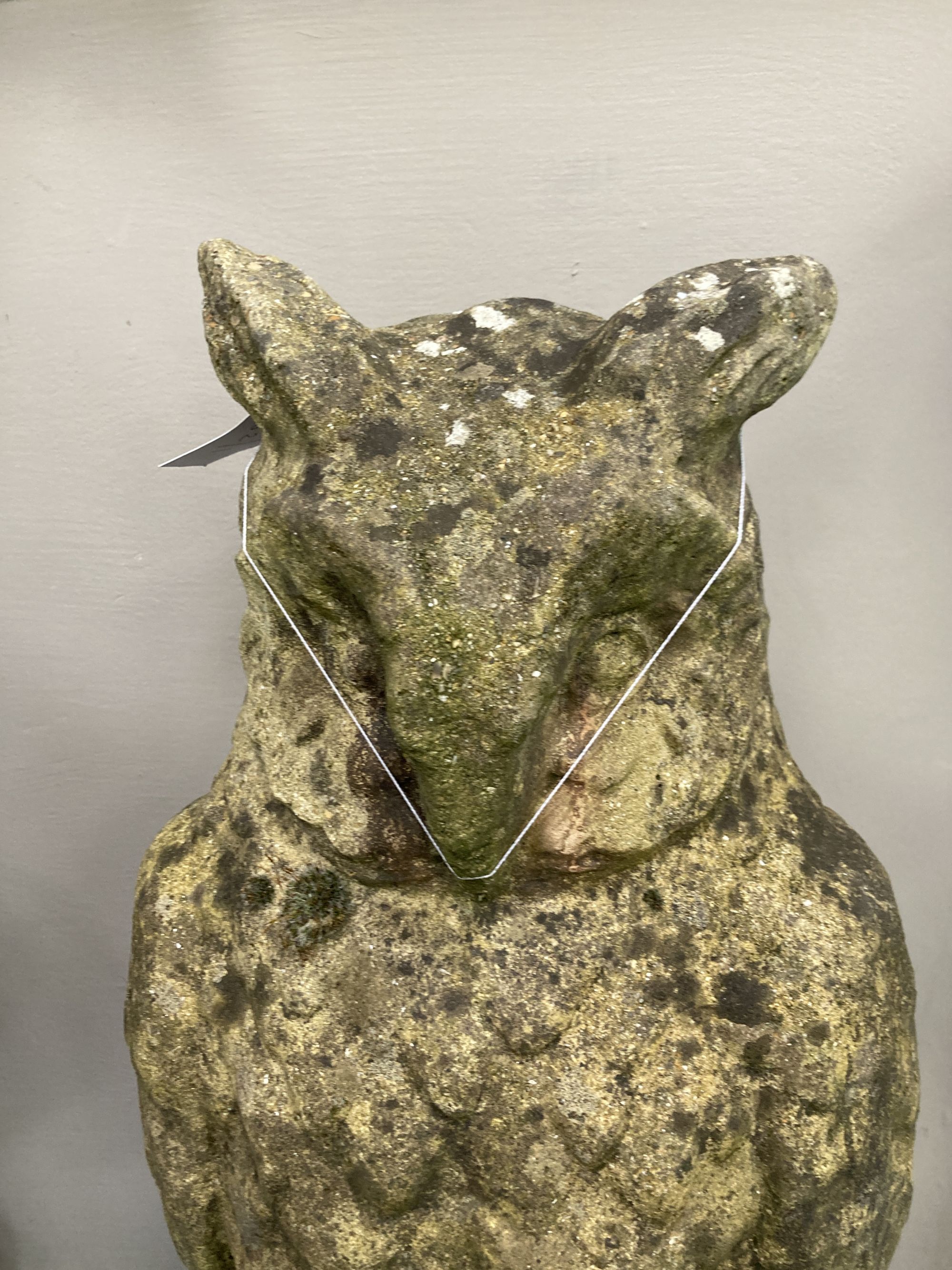 A reconstituted stone garden ornament modelled as an owl, height 70cm